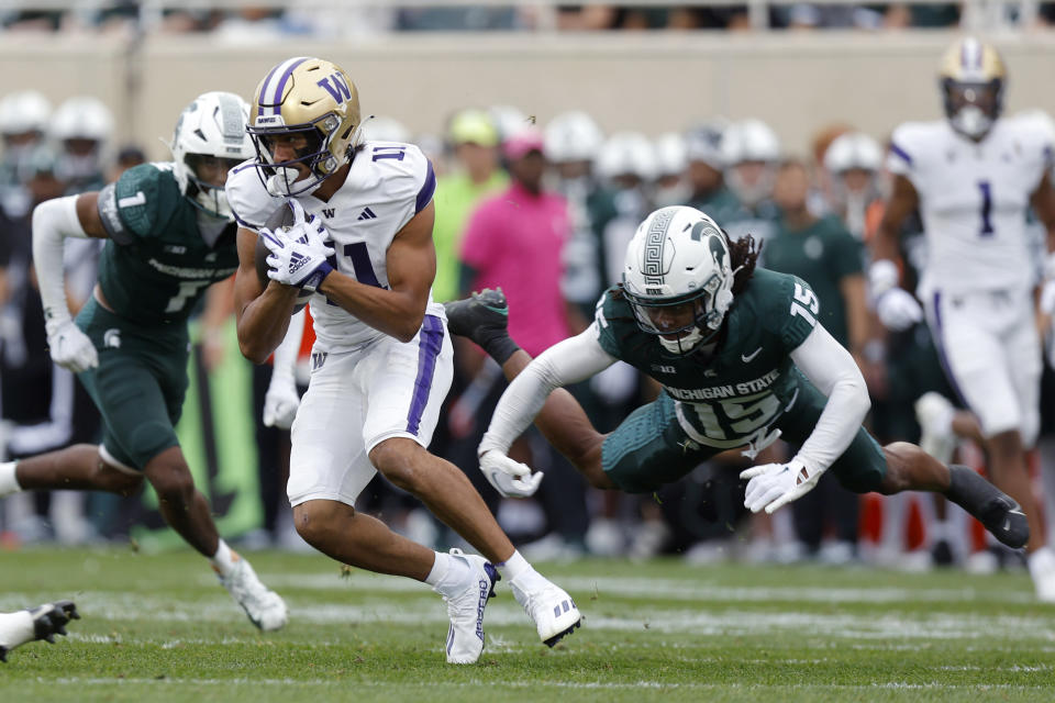 Washington's Jalen McMillan (left) was one of several Huskies to feast on Michigan State's defense Saturday. (AP Photo/Al Goldis)