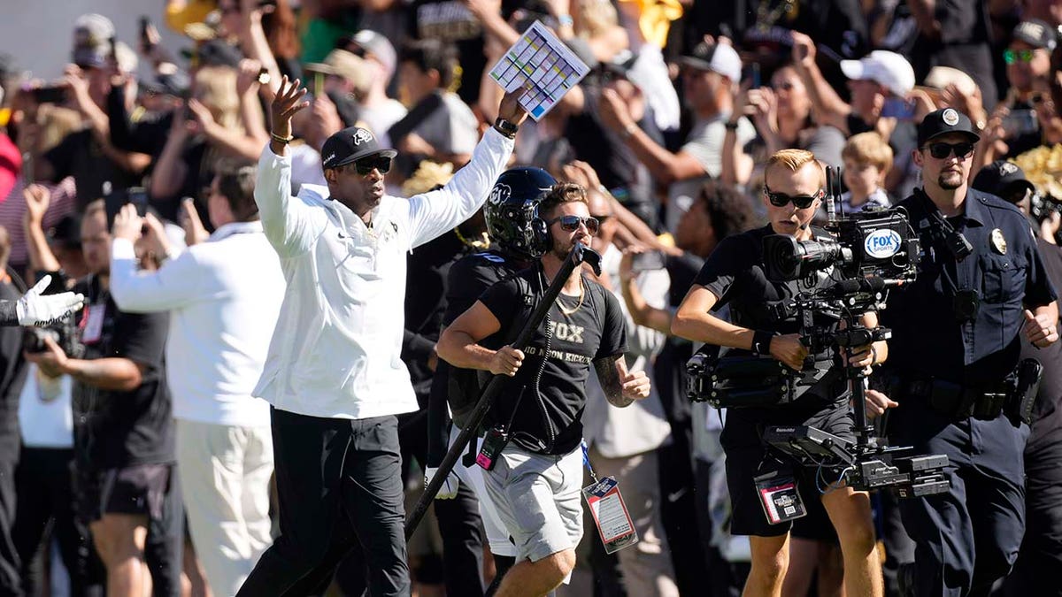 Deion Sanders celebrates during a Colorado game