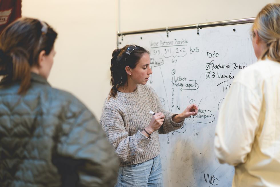 unspun co founder and eckhaus latta designers stand in front of a whiteboard discussing an equation for a pant material weave