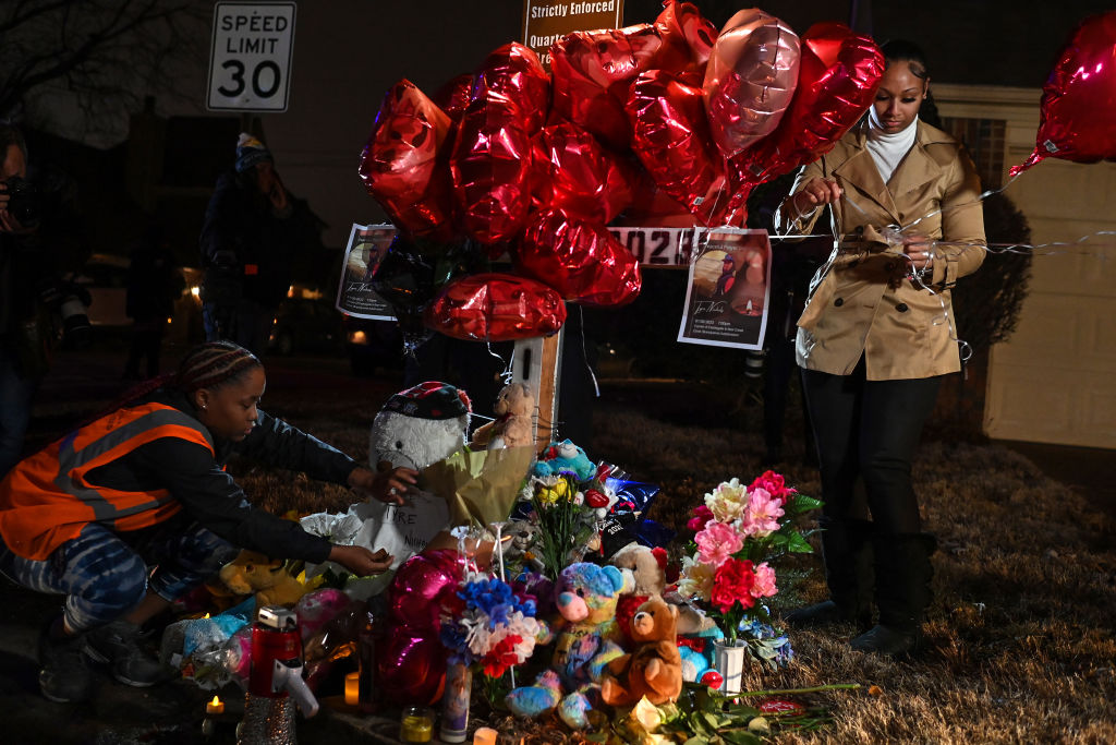 Sierra Rogers Makes Adjustments At A Makleshift Memorial For Tyre Nichols In Memphis, Tennessee