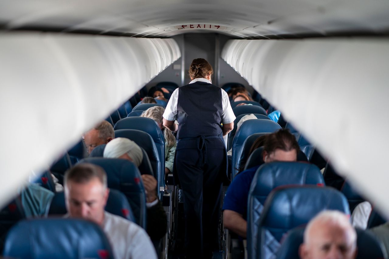 QUEENS, NY - MAY 04: Passengers and flight attendants aboard a flight from LaGuardia Airport bound for Kansas City International Airport on Wednesday, May 4, 2022 in Queens, NY. (Kent Nishimura / Los Angeles Times via Getty Images)