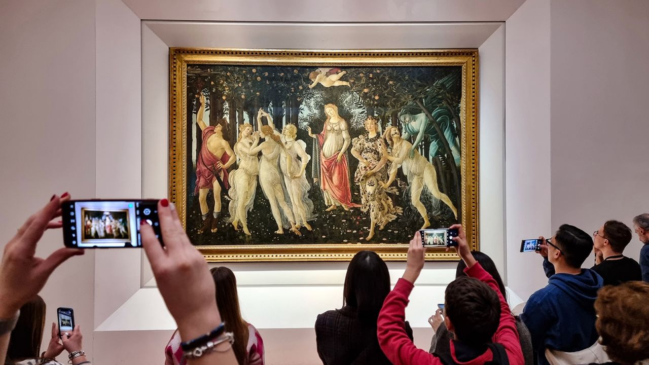 FLORENCE, ITALY - DECEMBER 30: Visitors view and photograph the painting Primavera (Spring) by the 15th century Italian Renaissance artist Sandro Botticelli at the Uffizi Gallery on December 30, 2022 in Florence, the capital of Italy's Tuscany region. The 16th century museum is famous for its collection of ancient sculptures and its paintings that date from the Middle Ages to the Modern period. (Photo by David Silverman/Getty Images)