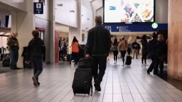 People walk through the Dallas/Fort Worth International Airport on November 24, 2021 in Dallas, Texas.