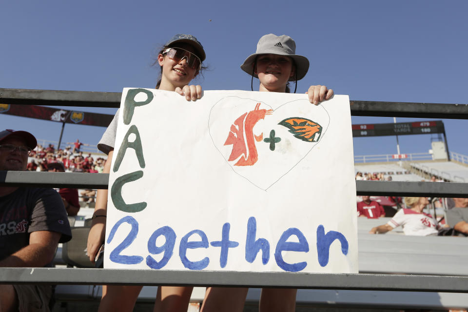 Washington State and Oregon State face off on the football field this weekend, but the schools are partners in an effort to keep the Pac-12 brand alive. (AP Photo/Young Kwak)