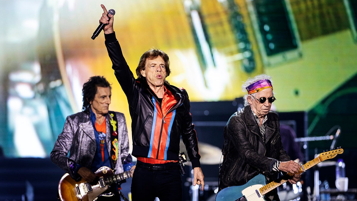 Ron Wood, Mick Jagger, and Keith Richards perform on stage