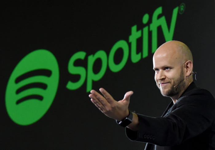 Photo of Spotify CEO Daniel EK with its logo behind him