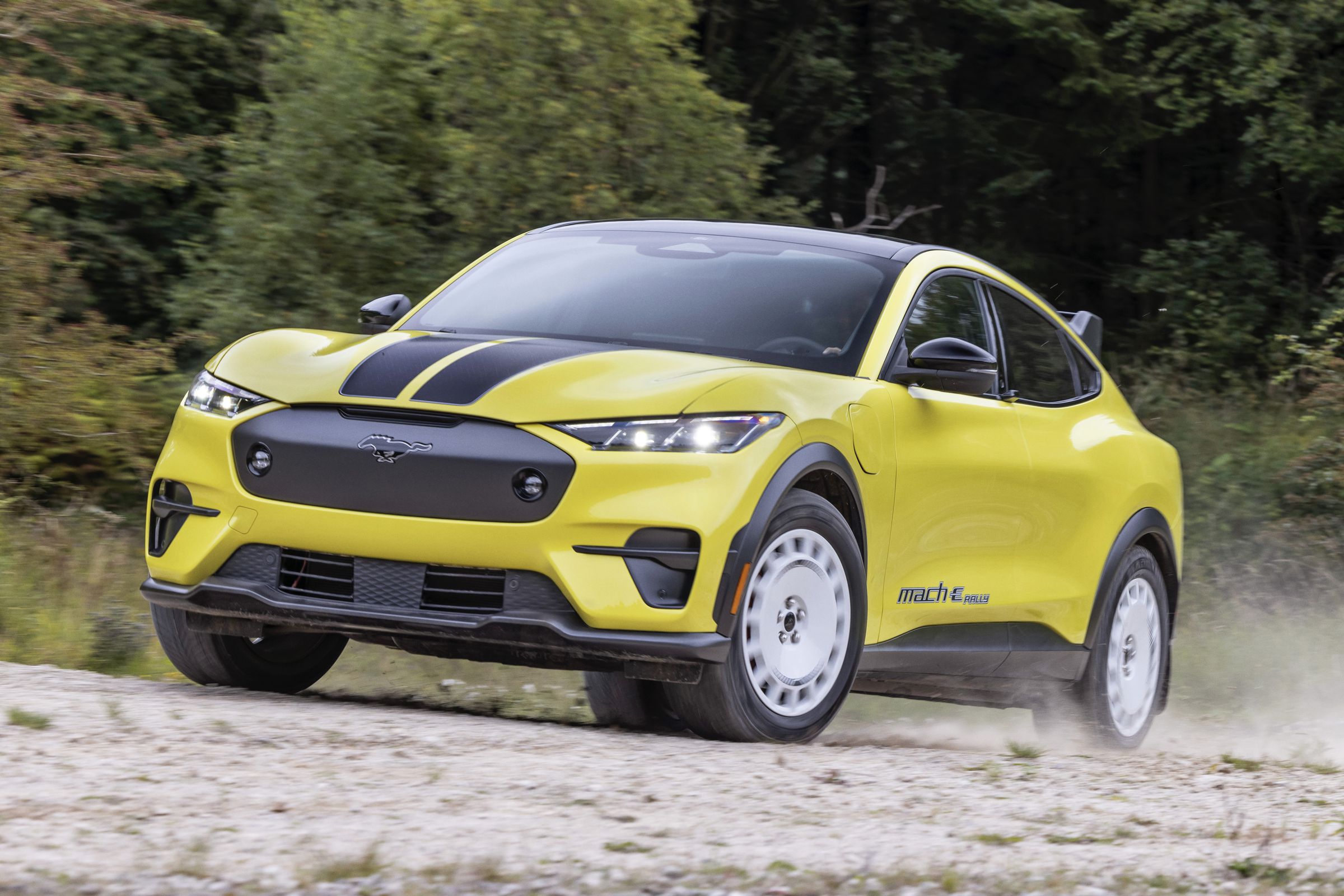 yellow mustang suv kicking dry dirt up as it drives