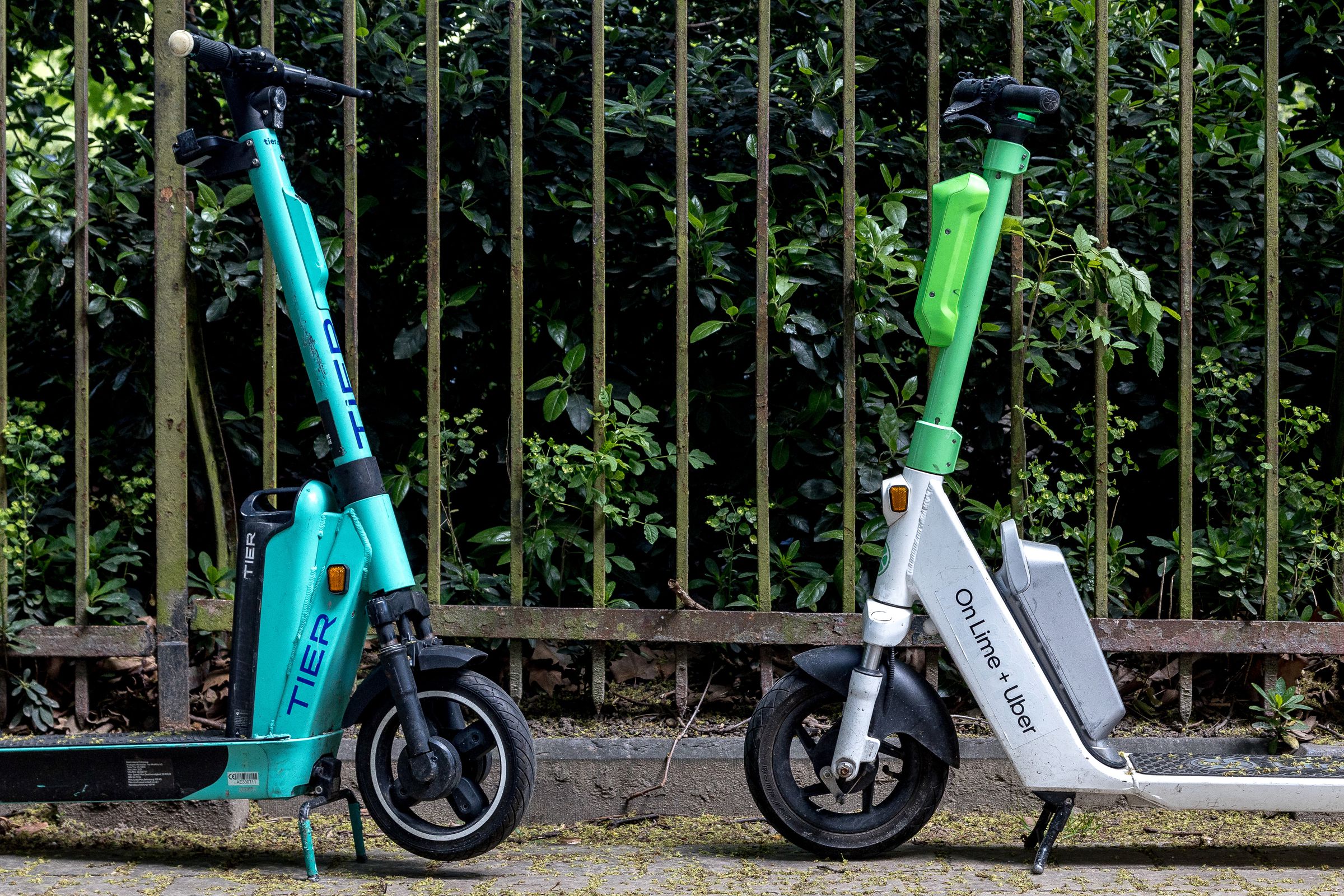 Lime and Tier scooter facing each other