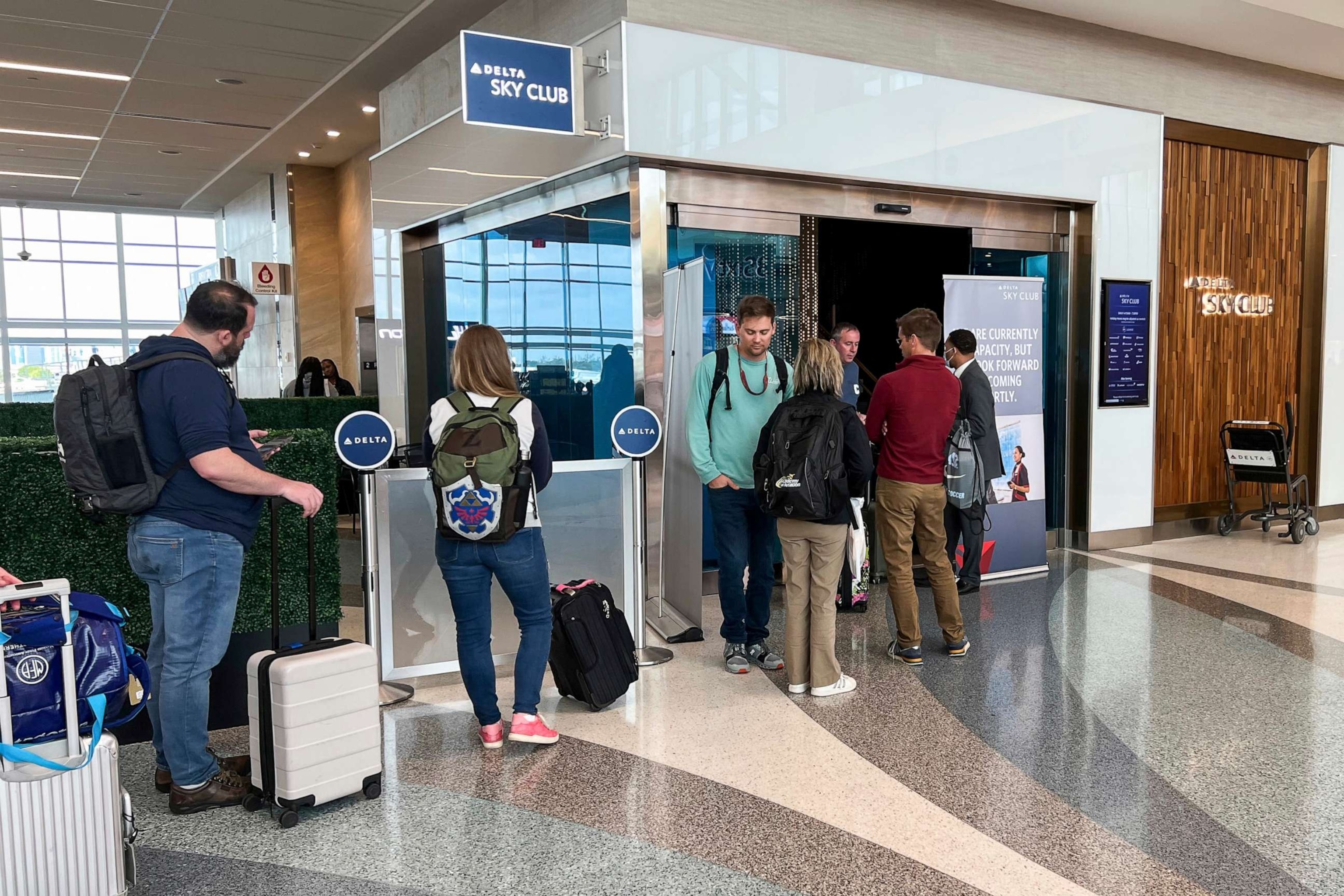 PHOTO: In this Jan. 22, 2023, file photo passengers wait in line outside the Delta Sky Club at Terminal 2 at Fort Lauderdale-Hollywood International Airport, in Fort Lauderdale, Fla.