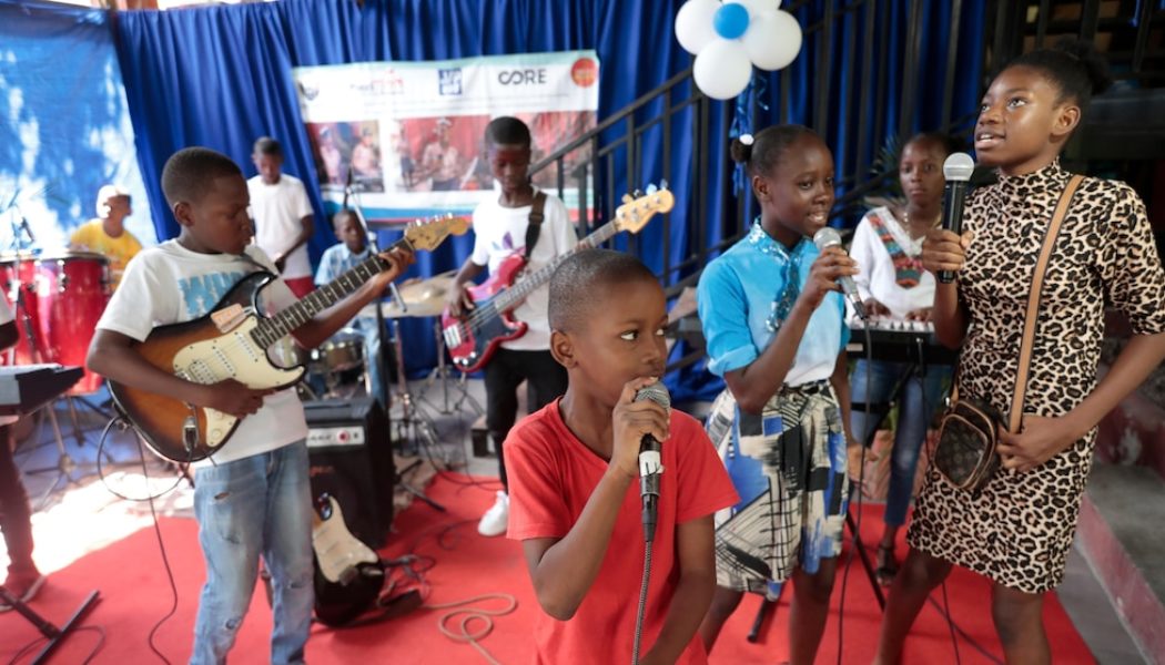 Haitian students play drums and strum guitars to escape hunger and gang violence