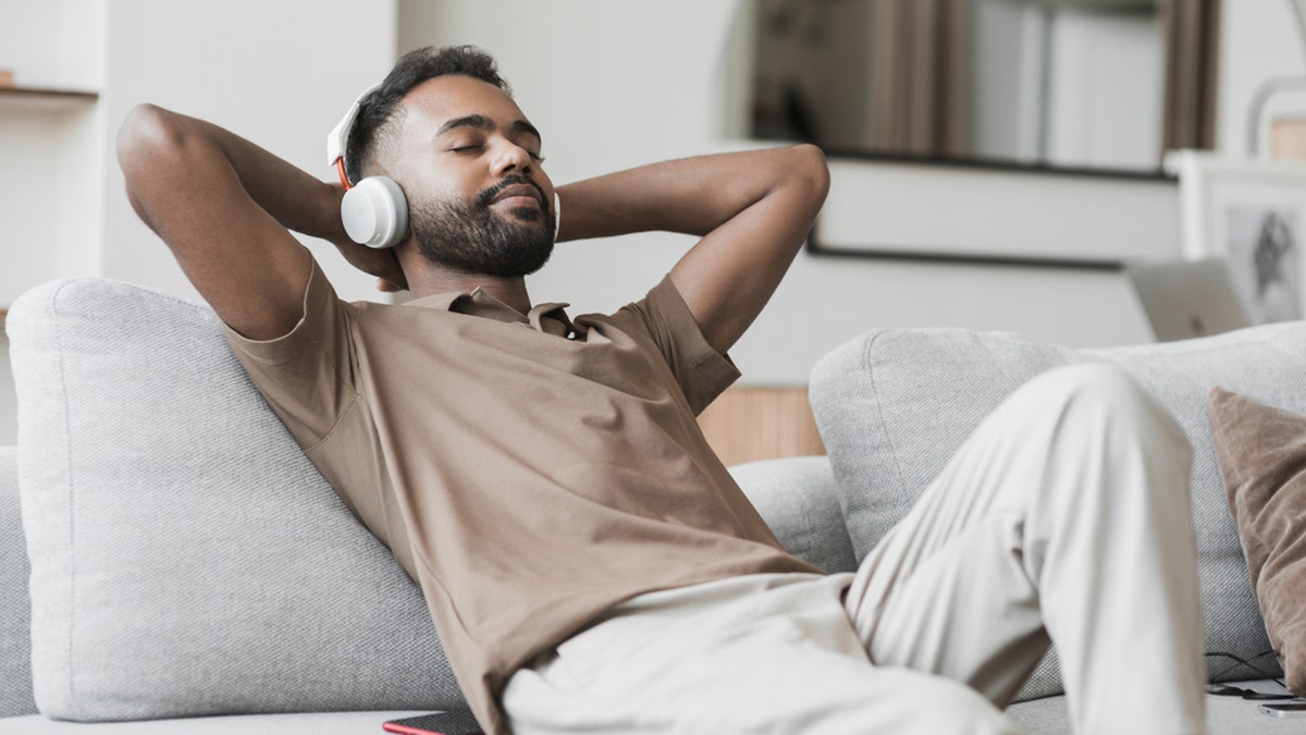 Man listening to music on couch