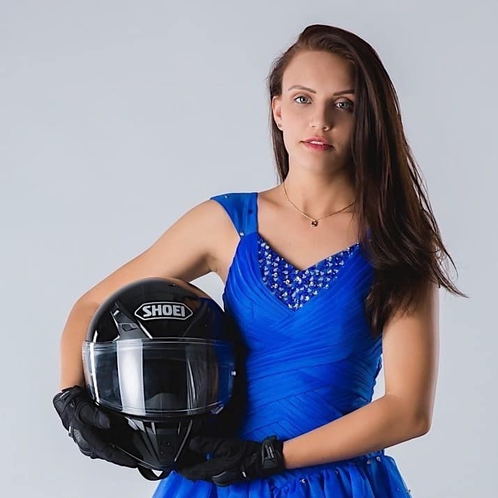 Woman holds a racing helmet.