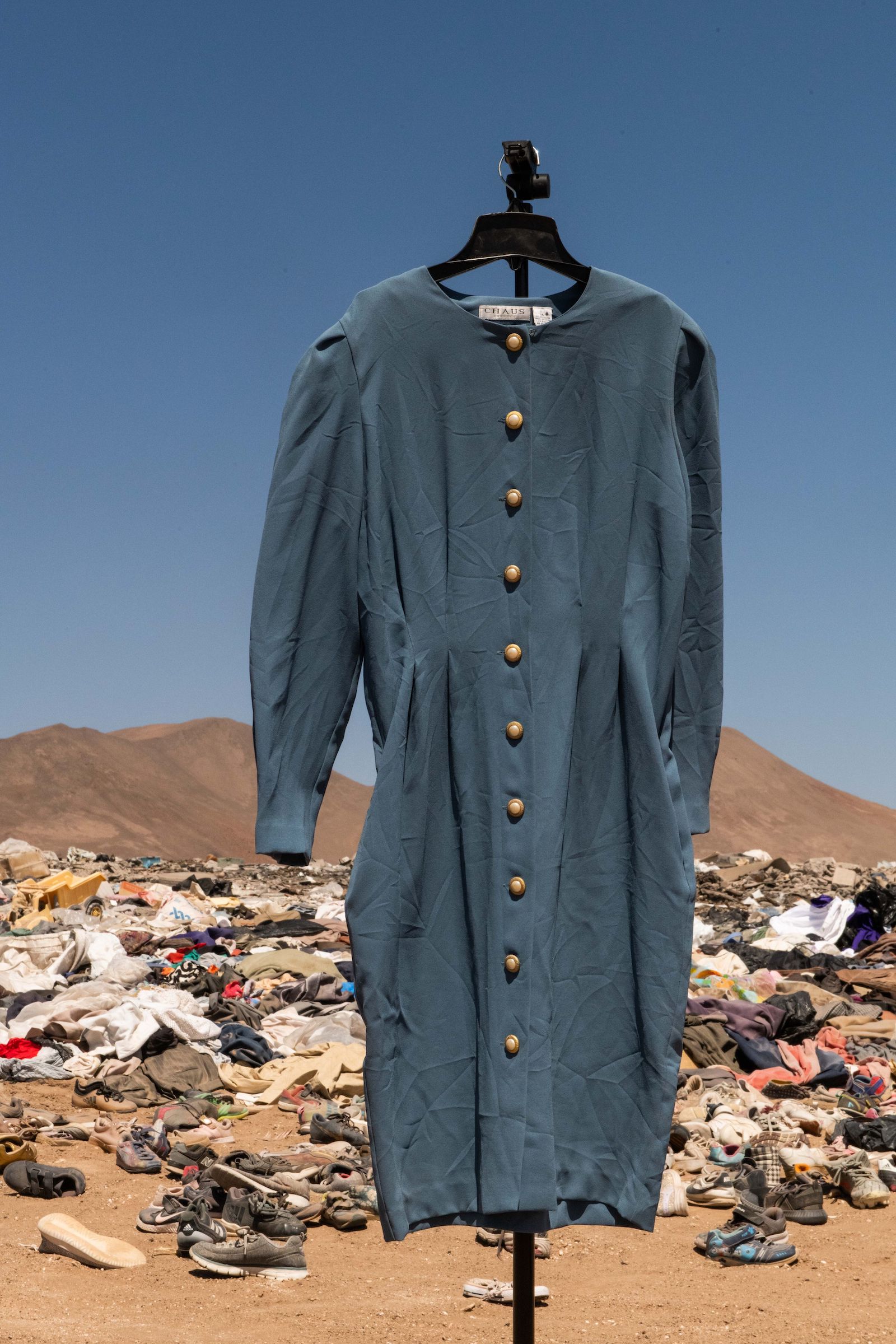 Millions of pieces of clothing lying in the middle of the desert are burned and turned into ash.