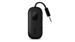 The AirFly Pro in black. It's a small, rounded plastic rectangle with an AUX plug protruding from one end.