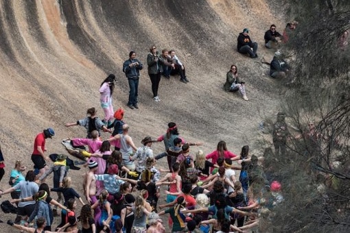 people under Wave Rock 