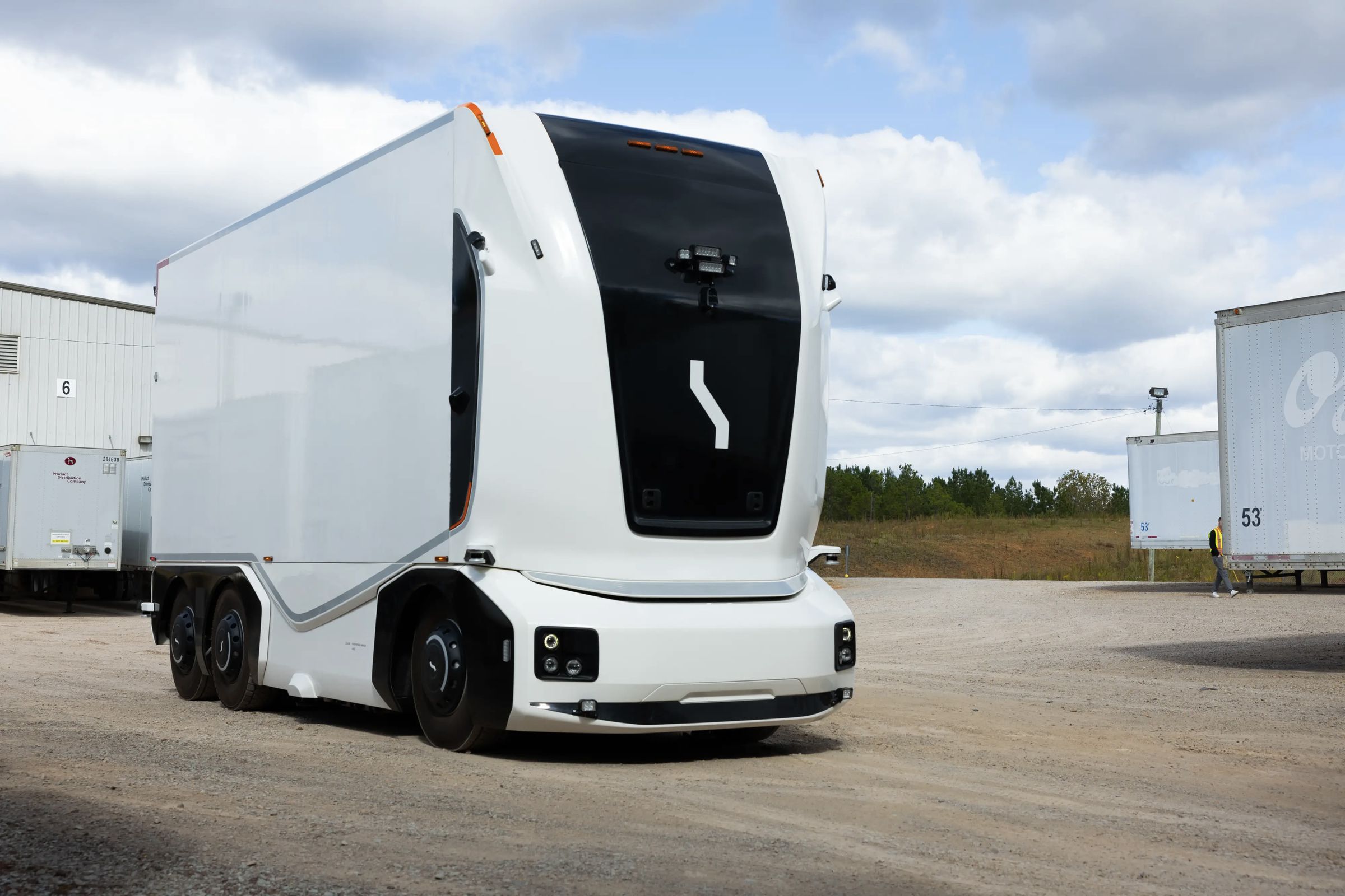 Boxy black-and-white truck with no windshield up front