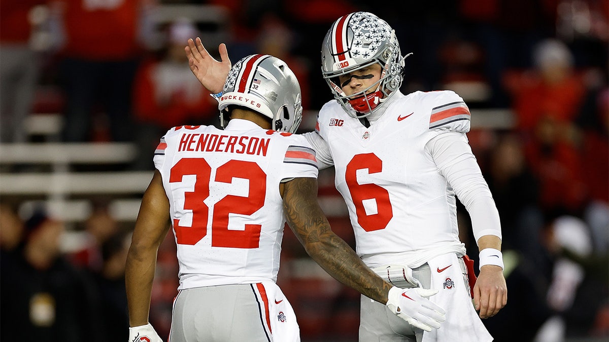 Kyle McCord and TreVeyon Henderson before a game