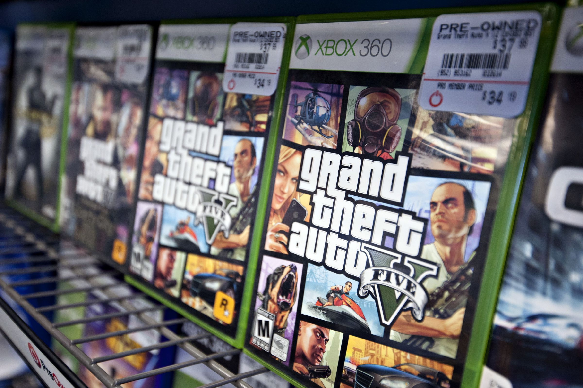 Boxed copes of GTA V sit on a shelf