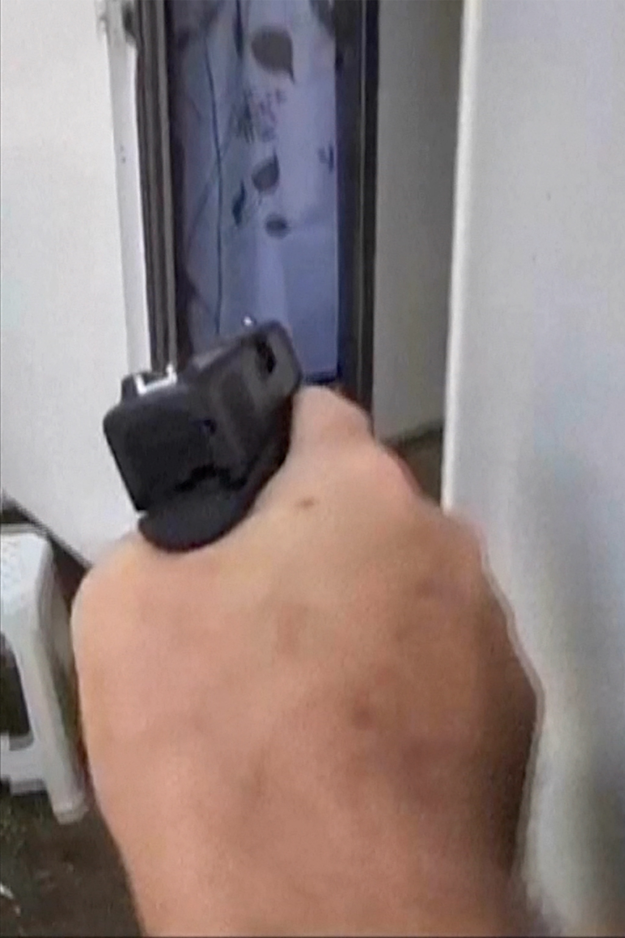 PHOTO: First responder Eran Masas points a 9mm pistol into the entrance of an RV on October 7, 2023, not knowing what he would find inside -- terrorists, or survivors from the Supernova music festival massacre.