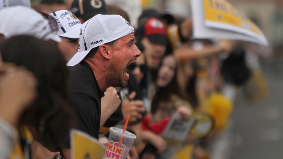 Bruins fan celebrates at a parade