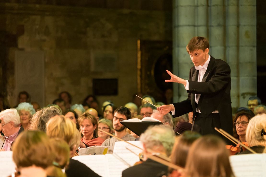 a young composer/conductor who stumbled across remnants of music scores at Auschwitz and has spent several years restoring them and working them into full compositions. He is now due to play with his orchestra at Sadler's Wells in London