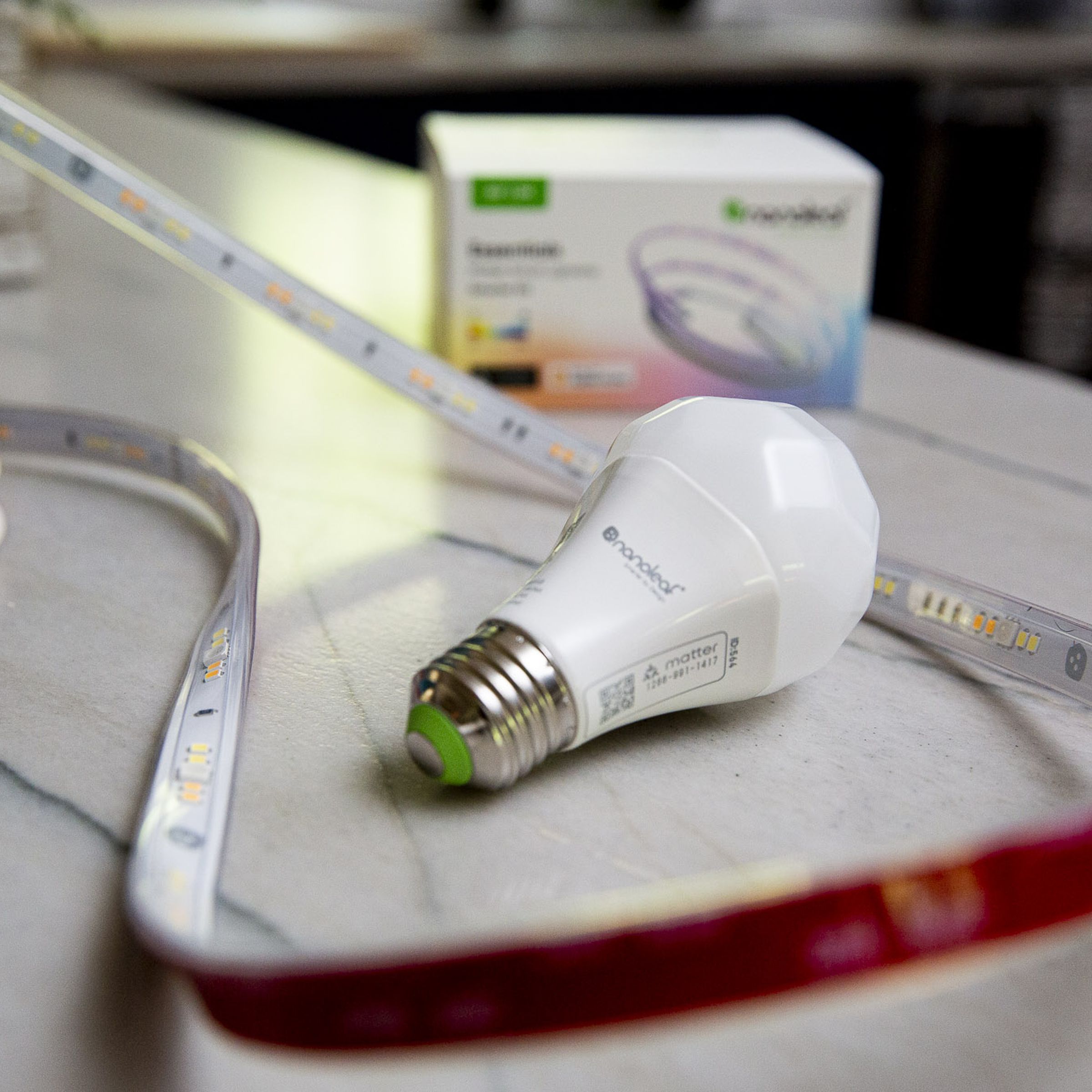 Nanoleaf Matter bulb and light strip on a table