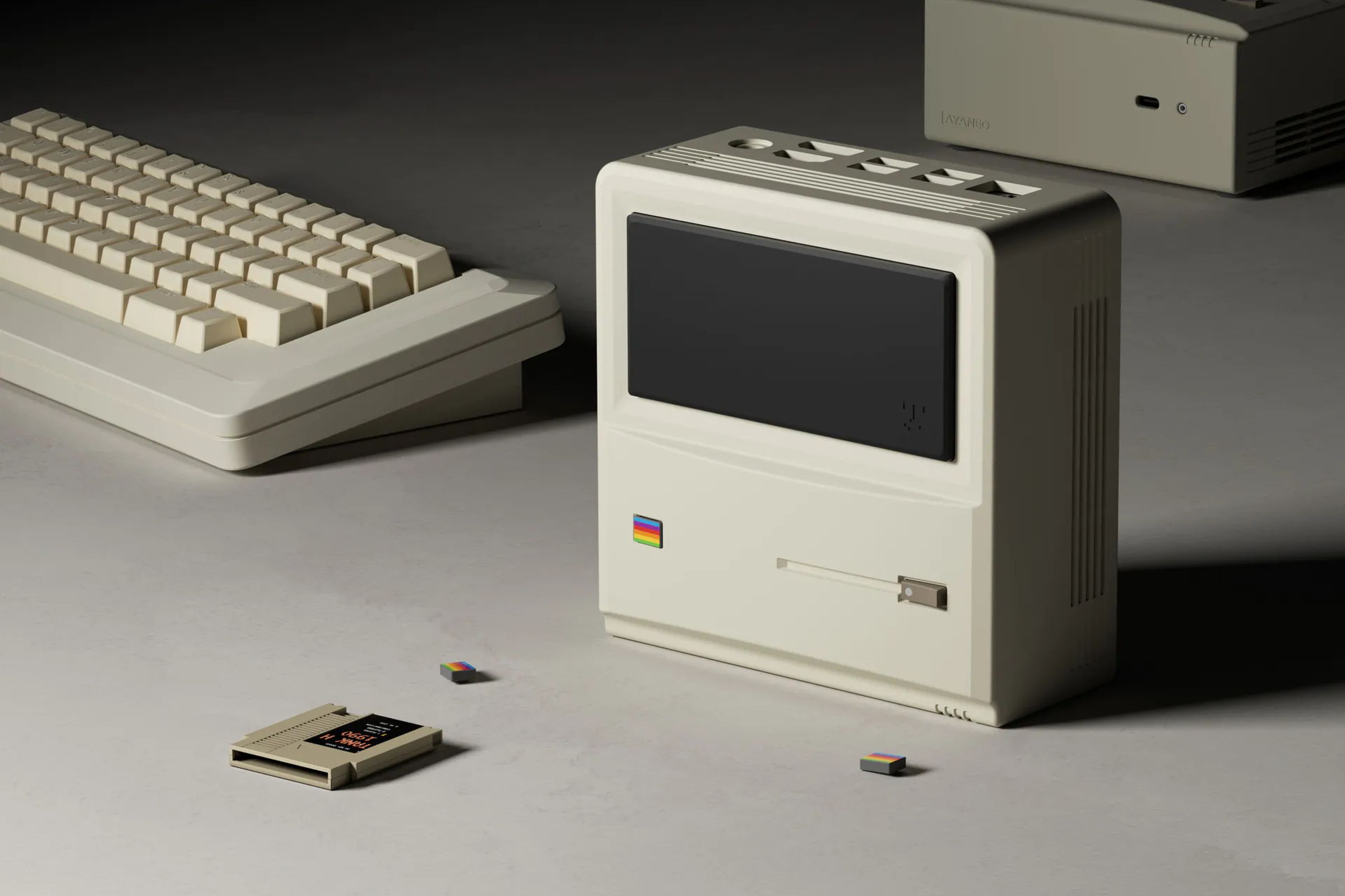 A beige computer sits on a table next to a game cartridge and keyboard.