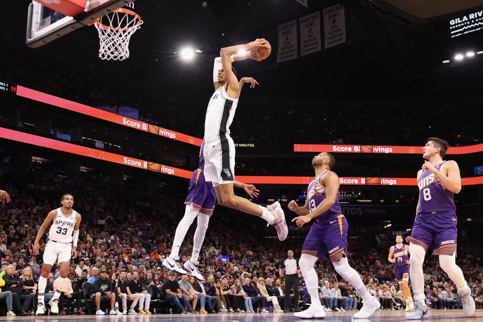 PHOENIX, ARIZONA - NOVEMBER 02: Victor Wembanyama #1 of the San Antonio Spurs slam dunks the ball against Keita Bates-Diop #21 of the Phoenix Suns during the first half of the NBA game at Footprint Center on November 02, 2023 in Phoenix, Arizona. NOTE TO USER: User expressly acknowledges and agrees that, by downloading and or using this photograph, User is consenting to the terms and conditions of the Getty Images License Agreement. (Photo by Christian Petersen/Getty Images)