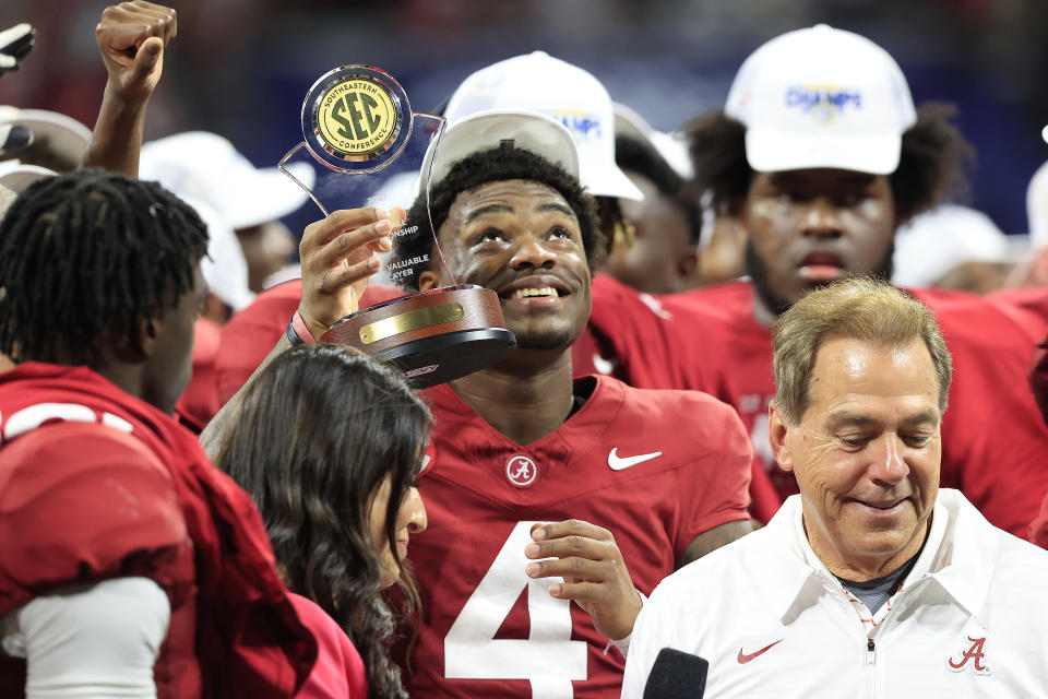 ATLANTA, GA - DECEMBER 02:  Alabama Crimson Tide starting quarterback Jalen Milroe (4)  holds up his MVP trophy after the college football SEC Championship game between the Alabama Crimson Tide and the Georgia Bulldogs on December 2, 2023 at the Mercedes-Benz Stadium in Atlanta, GA.  (Photo by David J. Griffin/Icon Sportswire via Getty Images)