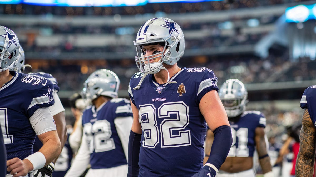 Jason Witten walks with helmet on