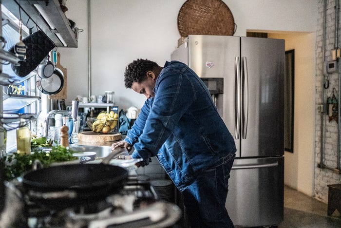 sad millennial man in kitchen