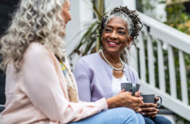 Women sit on steps and talk boundaries in relationships