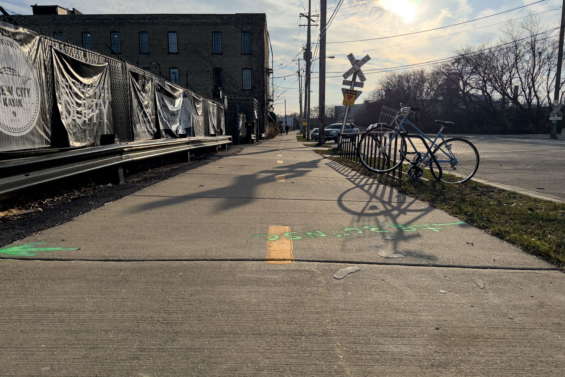 A low-to-the-ground shot of a cycle track, centered over the dotted yellow stripe in the middle.