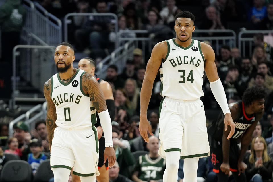 Milwaukee Bucks Giannis Antetokounmpo (34) and Damian Lillard (0) during the first half of an NBA basketball game against the Houston Rockets Sunday, Dec. 17, 2023, in Milwaukee. (AP Photo/Aaron Gash)