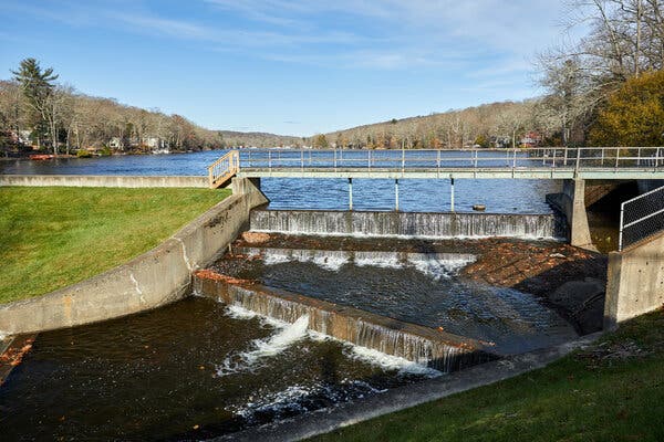 Looking across a large body of water that flows down a series of dams.