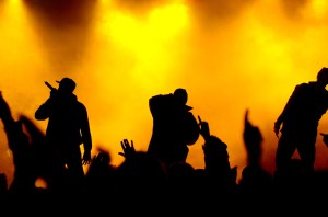 three rapper on stage. little noise and artefacts due to high iso