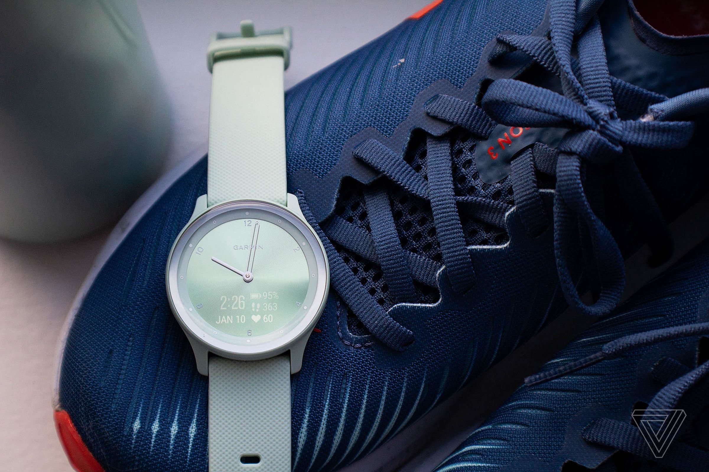 Garmin Vivomove Sport on top of a blue pair of sneakers