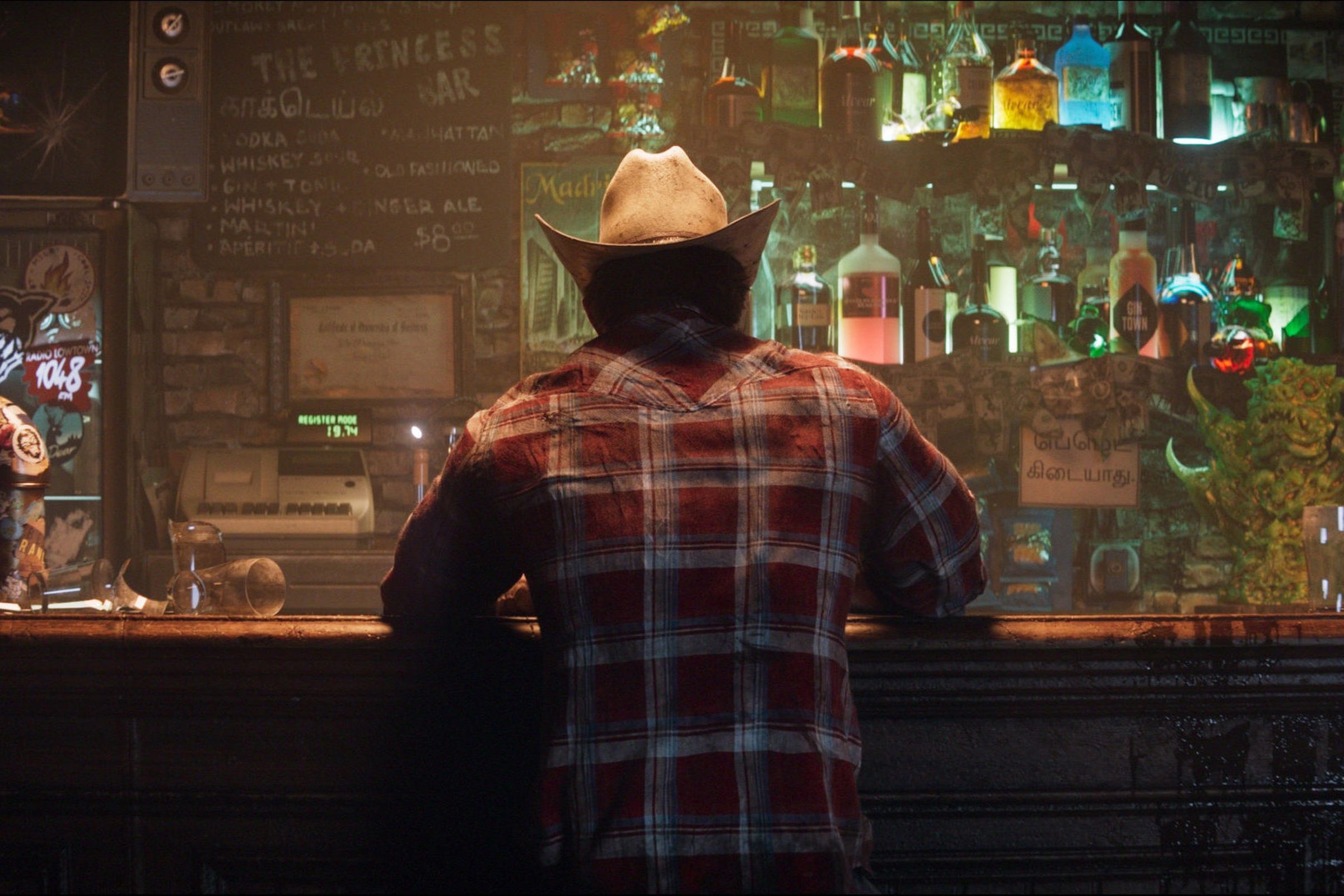 Wolverine stands at a bar. 