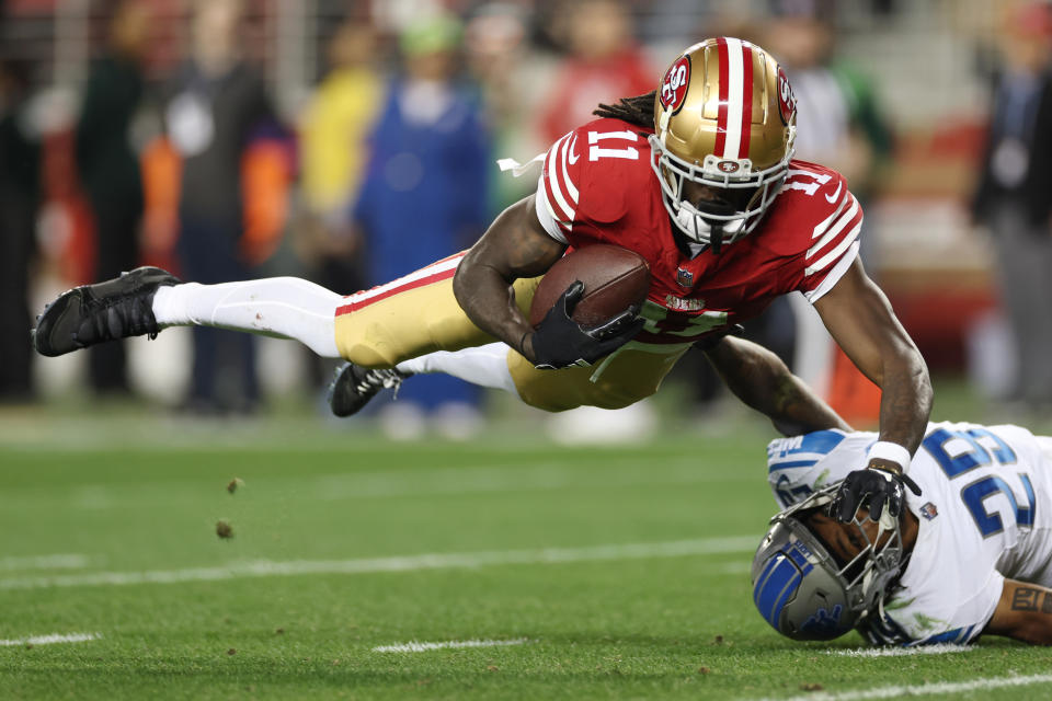 Brandon Aiyuk of the San Francisco 49ers catches a pass that was tipped by Kindle Vildor of the Detroit Lions during his team's comeback win in the NFC championship game. (Photo by Ezra Shaw/Getty Images)