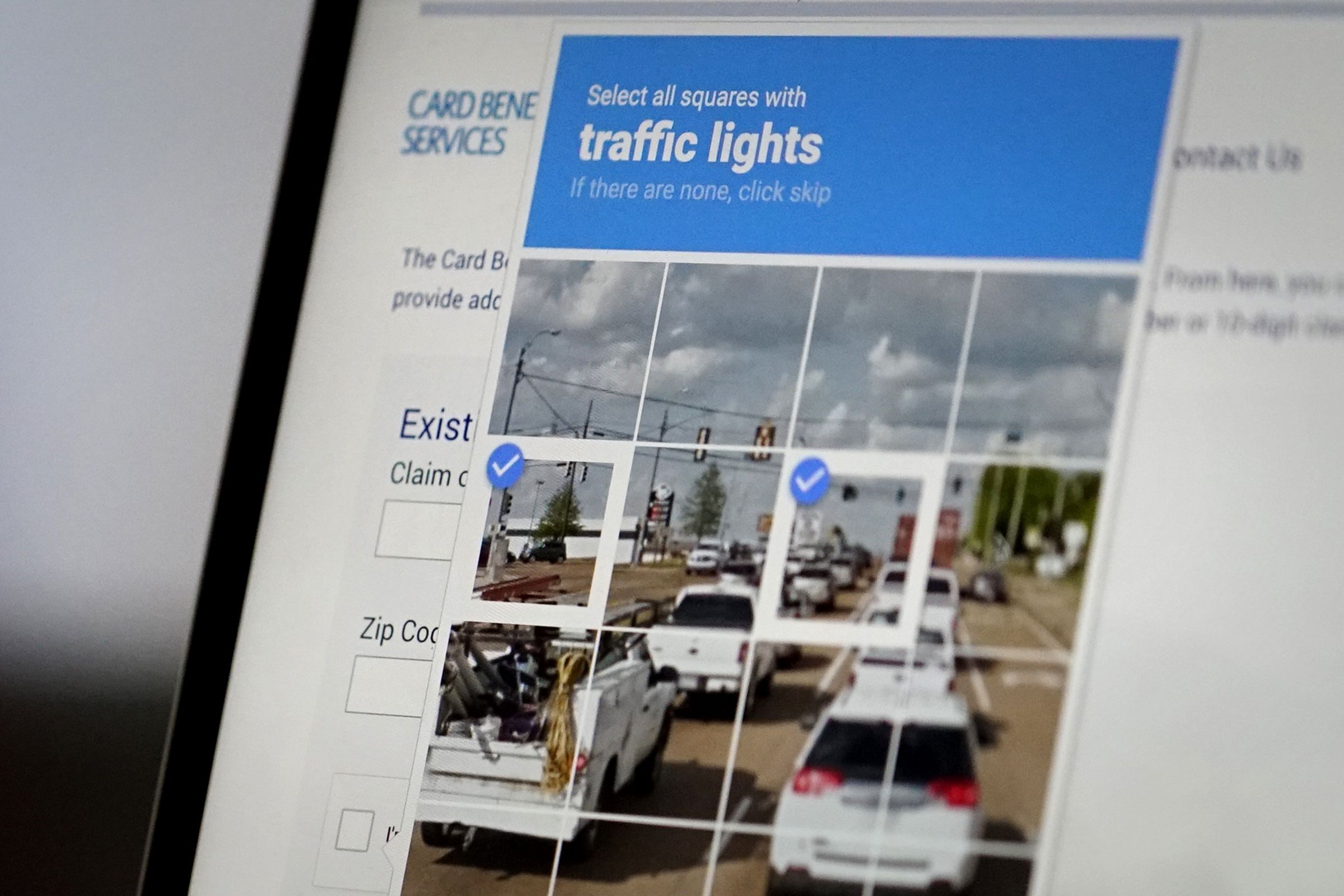 A photograph of a CAPTCHA grid on a screen.