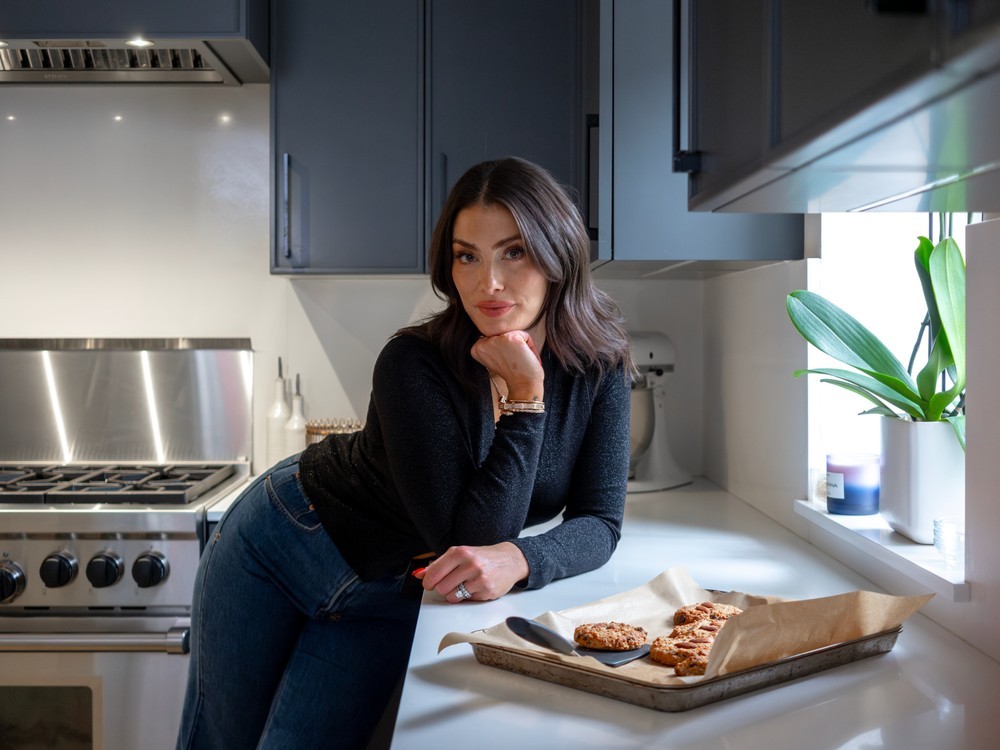 woman in kitchen with baking sheet