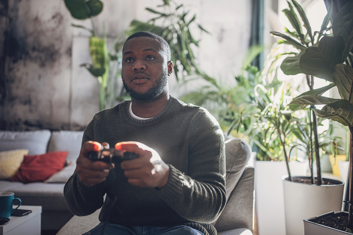 Focused Man Gaming Intensely on Console