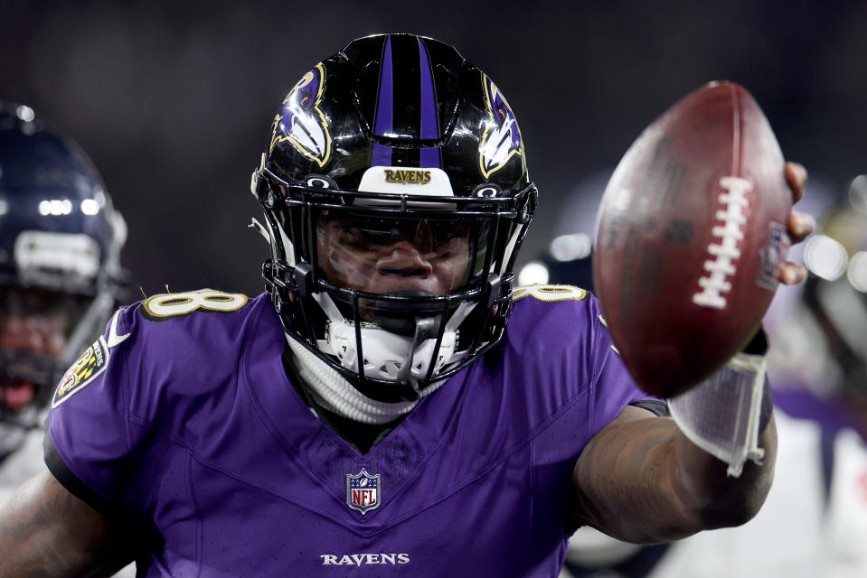 BALTIMORE, MARYLAND - JANUARY 20: Lamar Jackson #8 of the Baltimore Ravens scores an 8 yard touchdown against the Houston Texans during the fourth quarter in the AFC Divisional Playoff game at M&T Bank Stadium on January 20, 2024 in Baltimore, Maryland. (Photo by Rob Carr/Getty Images)