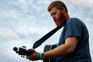 FARMVILLE, VIRGINIA - AUGUST 26: Christopher Anthony Lunsford, who goes by the stage name Oliver Anthony, warms up next to a loading dock behind the buildings lining Main Street before a surprise performance at the Rock the Block street festival on August 26, 2023 in Farmville, Virginia. Anthony's song "Rich Men North of Richmond" gained notoriety after it was played at the recent Republican presidential primary debate. (Photo by Samuel Corum/Getty Images)