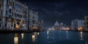 Lanterns float on the water at night next to multistory waterfront buildings. 