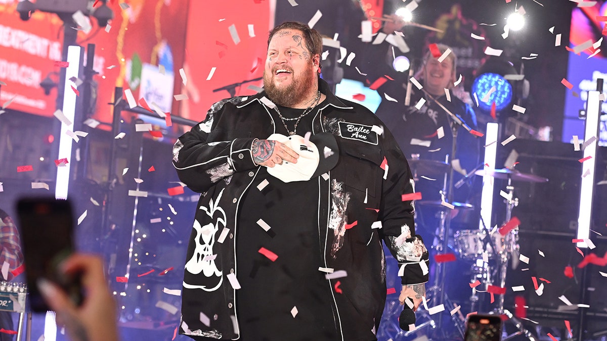 Jelly Roll standing on stage with confetti falling down