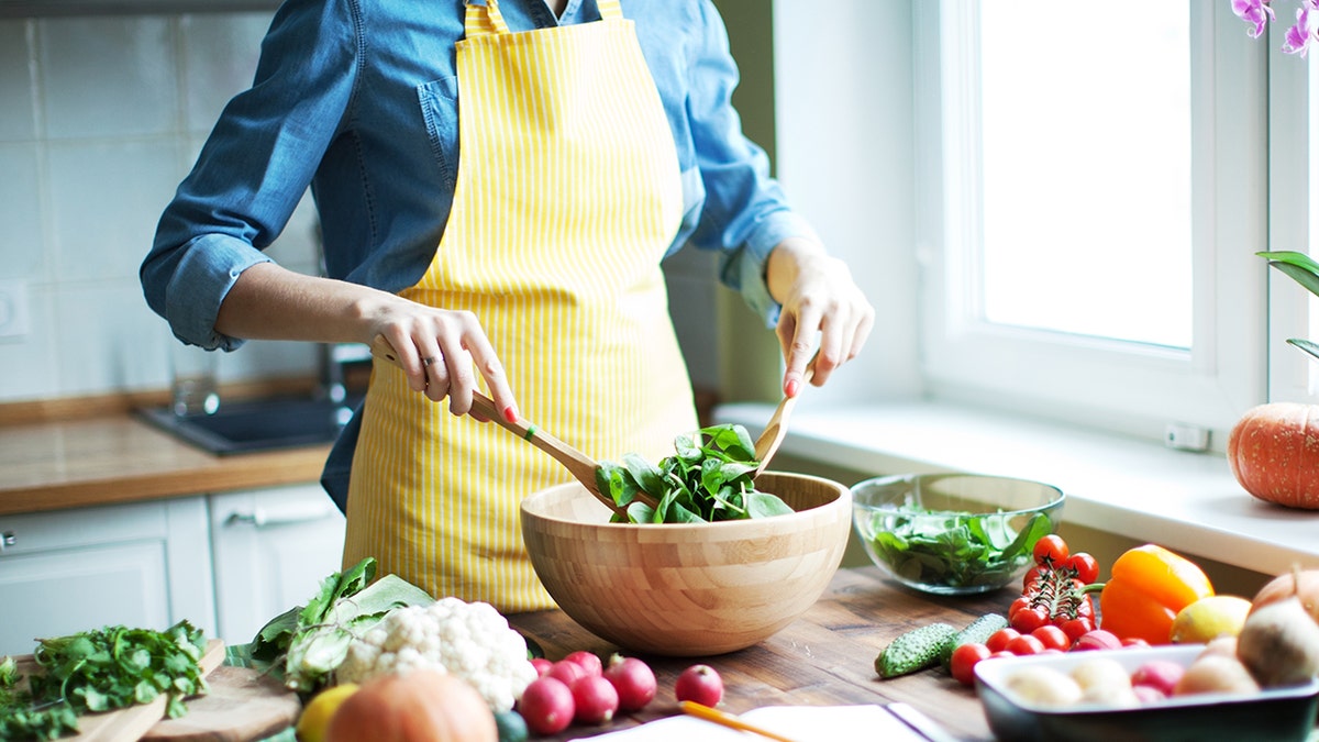 woman making healthy salad