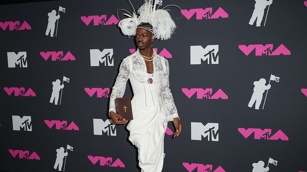 Lil Nas X holding Bible