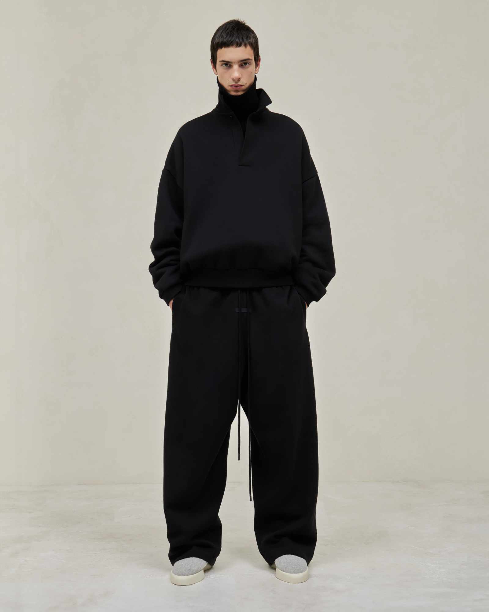 Models wear Fear of God ESSENTIALS' Winter 2023 hoodies, sweatshirts, t-shirts, and sweatpants