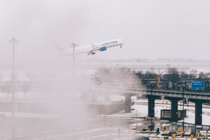 An airplane takes off during blizzard conditions at O'Hare Airport on January 12, 2024 in Chicago, Illinois. Over 1,900 flights have been canceled nationwide due to a large winter storm bringing blizzard conditions.